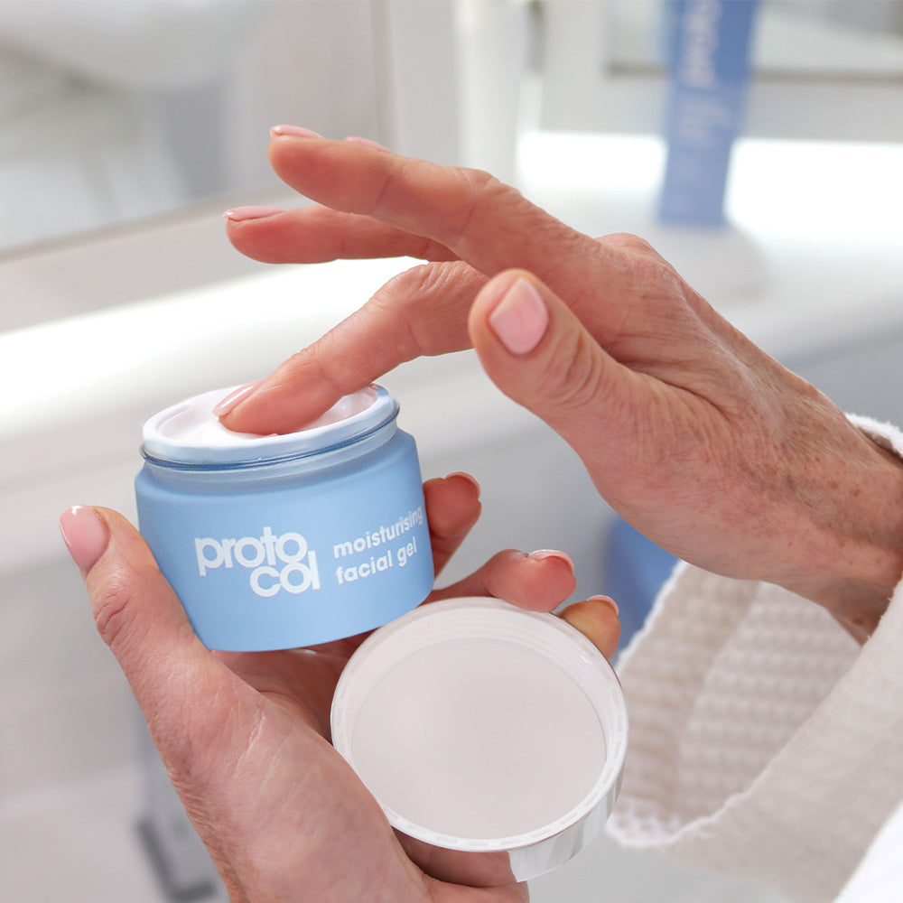Hand dipping into a pot of Moisturising Facial Gel