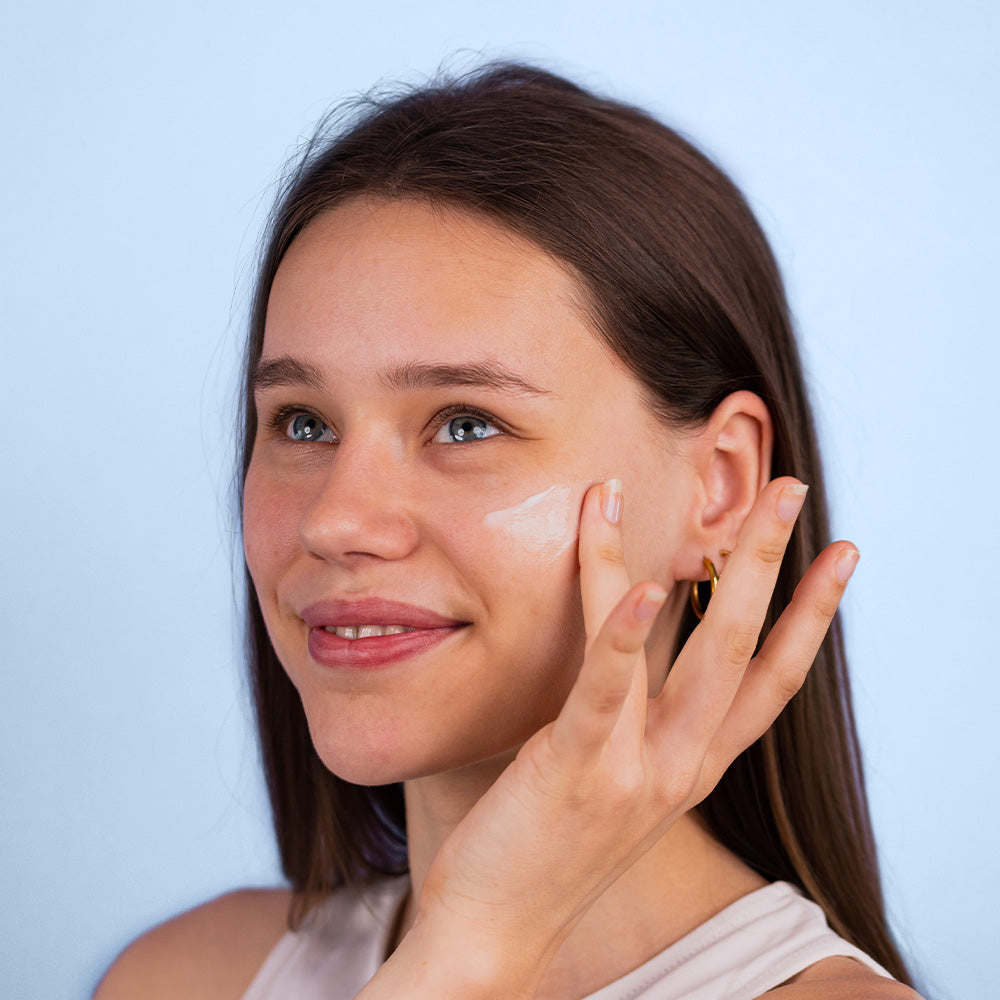Female putting on the Moisturising Facial Gel on their cheek